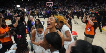 Oct 10, 2025; Phoenix, Arizona, USA; Las Vegas Aces center A'ja Wilson (22) celebrates with teammates after game four of the 2025 WNBA Finals at Mortgage Matchup Center. Mandatory Credit: Joe Camporeale-Imagn Images