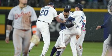 Oct 10, 2025; Seattle, Washington, USA; Seattle Mariners second baseman Jorge Polanco (7) celebrates with teammates after hitting a walk off single as Detroit Tigers shortstop Javier Baez (28) leaves the field during the fifteenth inning during game five of the ALDS round for the 2025 MLB playoffs at T-Mobile Park.  Mandatory Credit: Stephen Brashear-Imagn Images